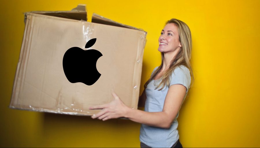 A female customer carries an Apple shopping bag at an Apple retail