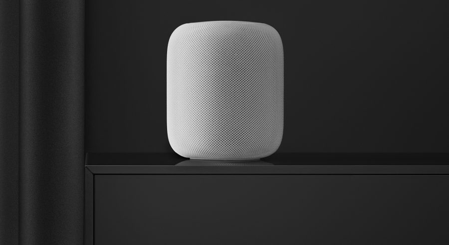 White HomePod on black table