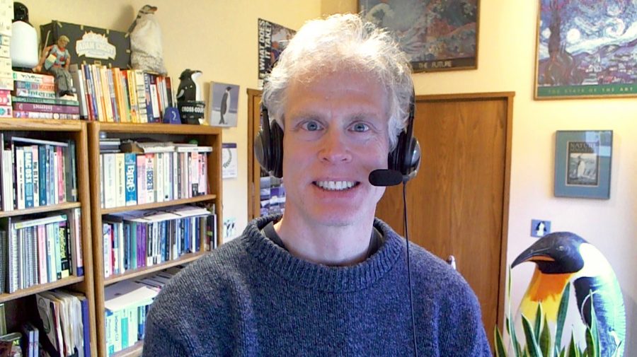 Adam Engst wearing a headset in his office