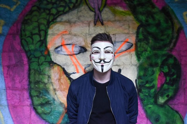 A creepy guy in an Guy Fawkes mask.