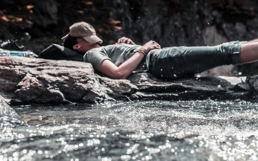A guy sleeping in a stream.