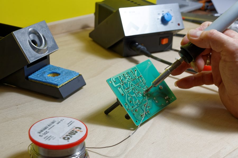 Someone soldering stuff on a circuit board.