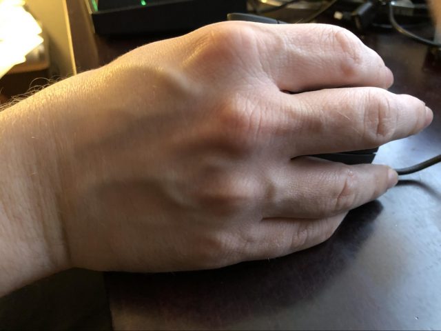 How my hand sits on the desk with the Anker vertical mouse.