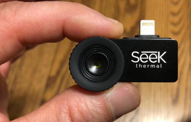 The Seek camera between two fingers.