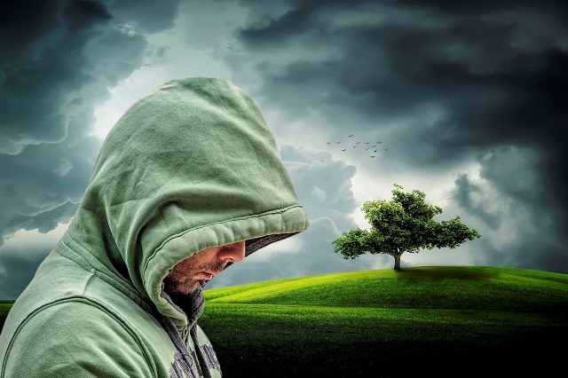 Photo of a hooded guy looking sad