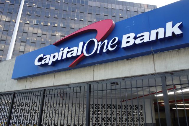 A Capital One Bank sign on the parking garage for the Rego Park Office Tower (formerly Queens Tower) at Junction Boulevard between 62nd Drive and Queens Boulevard in Rego Park, Queens. The bank itself is located at the front of the building on Queens Boulevard.