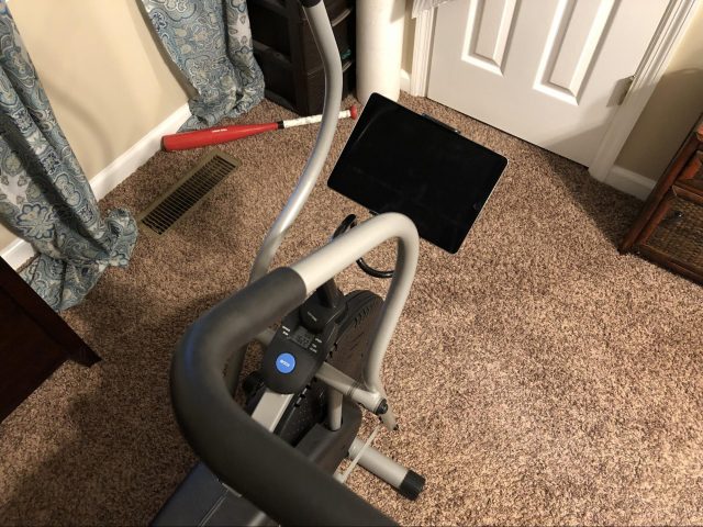 An iPad mounted to an exercise bike.