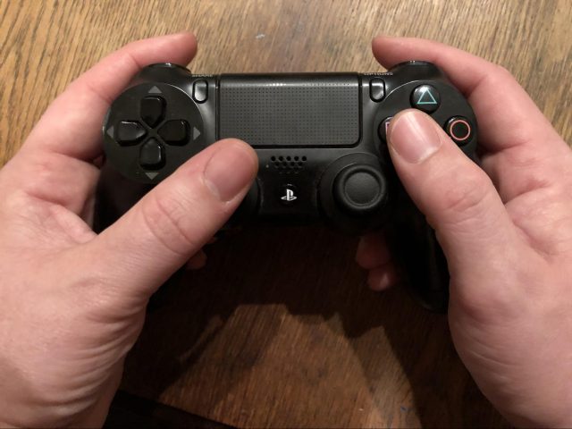 How to hold a PS4 controller.